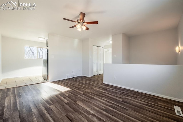 empty room featuring ceiling fan and dark hardwood / wood-style flooring