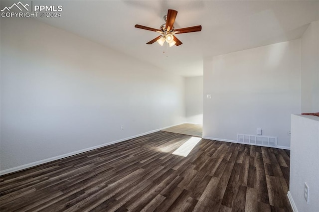 spare room featuring ceiling fan and dark wood-type flooring