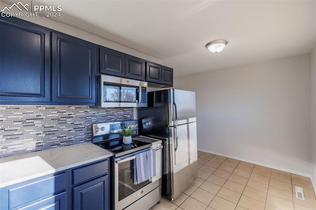 kitchen with blue cabinets, stainless steel appliances, light tile patterned floors, and tasteful backsplash