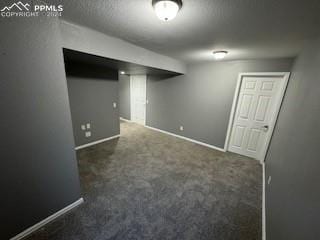 basement featuring dark carpet