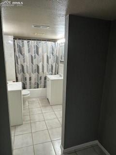 bathroom featuring toilet, vanity, and tile patterned flooring