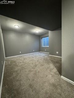 empty room with dark carpet