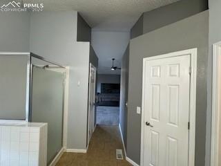 corridor featuring a textured ceiling