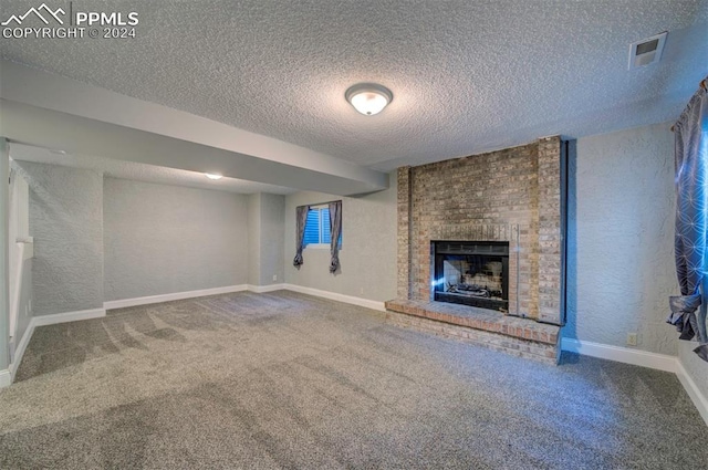 unfurnished living room with carpet flooring, a textured ceiling, and a fireplace