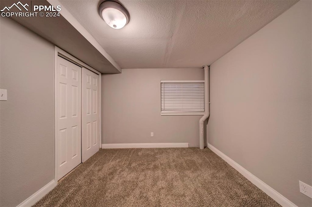 unfurnished bedroom with a closet, a textured ceiling, and carpet flooring