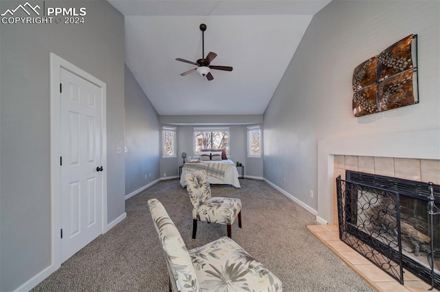 carpeted bedroom with a fireplace, high vaulted ceiling, and ceiling fan