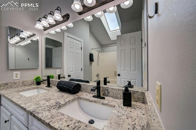 bathroom with vanity, vaulted ceiling with skylight, and shower / bathtub combination