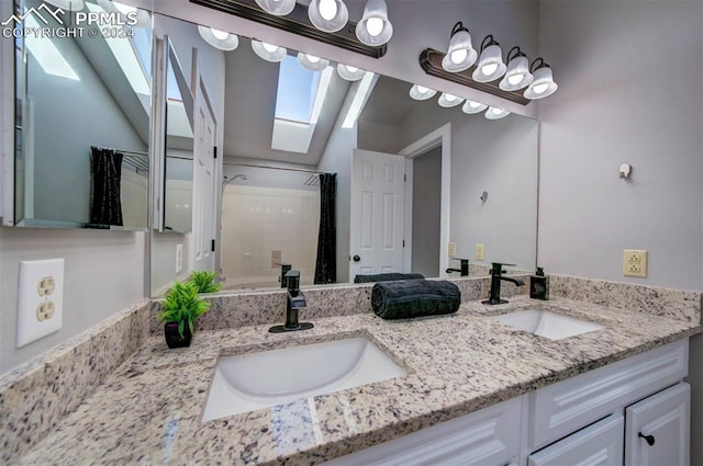 bathroom with tub / shower combination, vanity, and a skylight