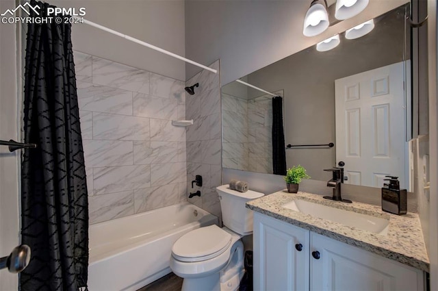 full bathroom with shower / tub combo with curtain, vanity, and toilet