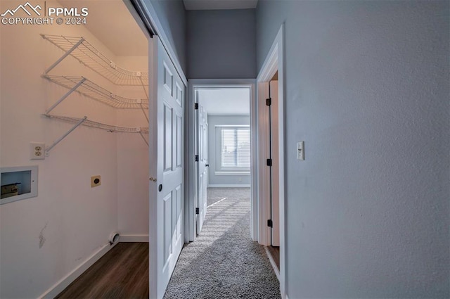 hallway featuring dark carpet