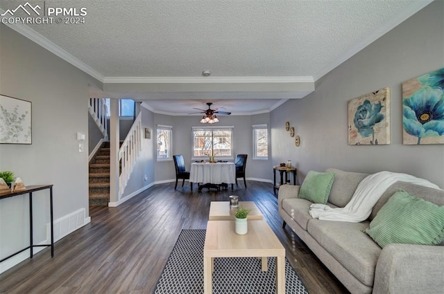 living room with crown molding, dark hardwood / wood-style floors, and a textured ceiling