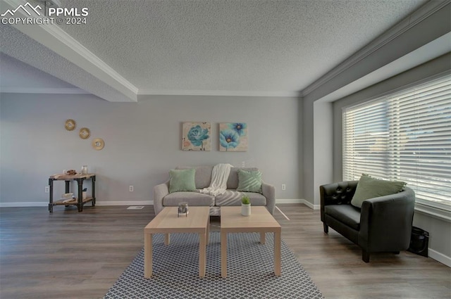 living room featuring hardwood / wood-style flooring, crown molding, and a textured ceiling