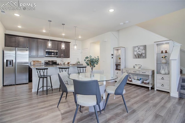 dining room featuring light hardwood / wood-style flooring and sink