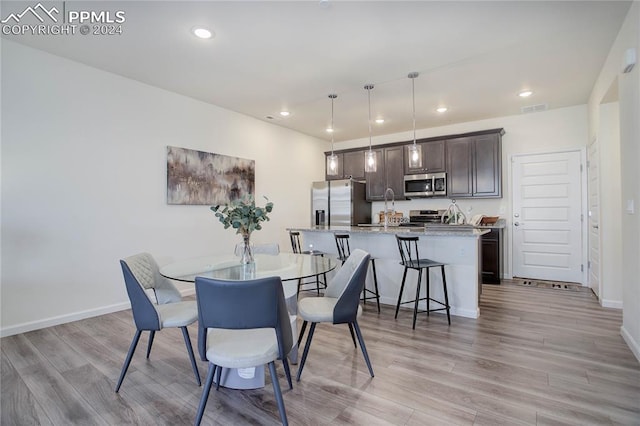 dining area featuring light wood-type flooring