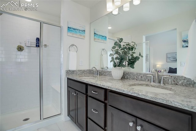 bathroom featuring vanity, tile patterned floors, and a shower with door