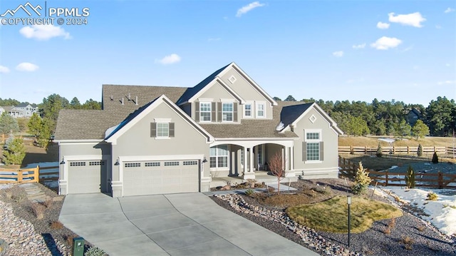 view of front of property featuring covered porch and a garage