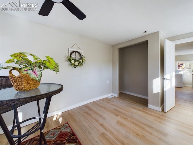 dining space with ceiling fan, light hardwood / wood-style flooring, and washer / dryer