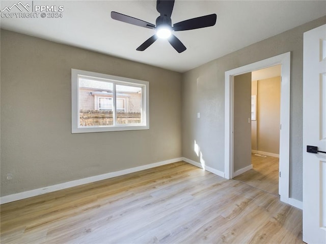 spare room with light hardwood / wood-style floors and ceiling fan