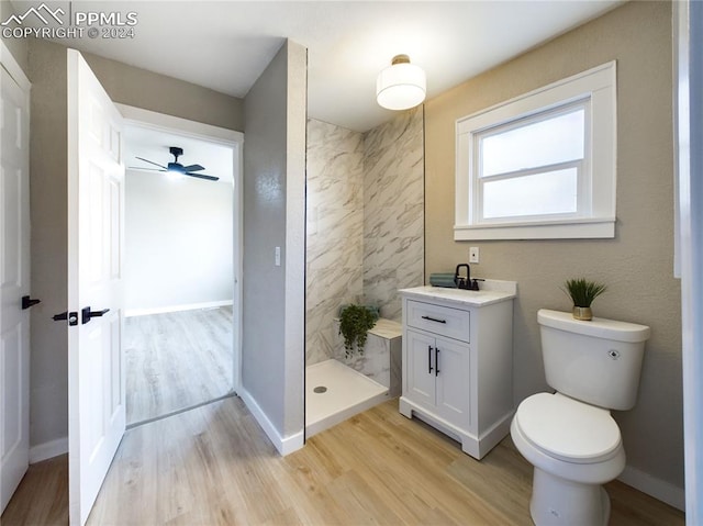 bathroom with ceiling fan, toilet, wood-type flooring, and vanity