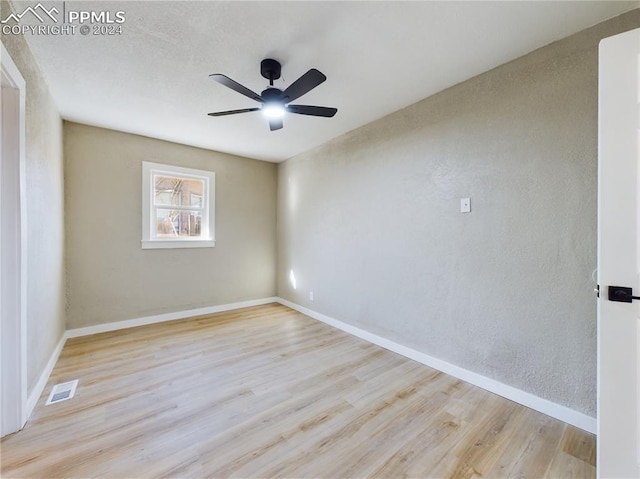 empty room with ceiling fan and light wood-type flooring