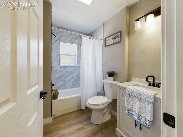 full bathroom featuring vanity, toilet, wood-type flooring, and shower / bath combo