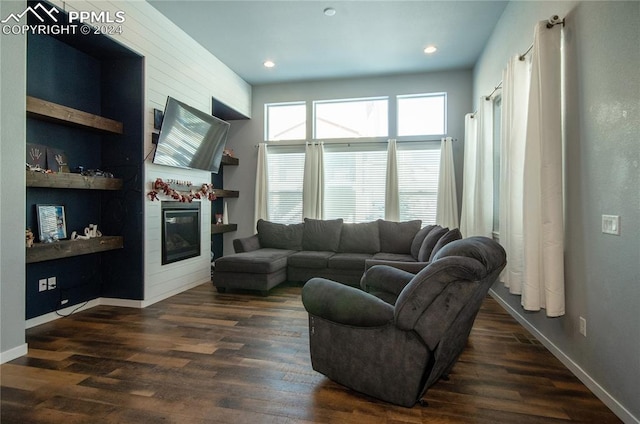 living room featuring dark hardwood / wood-style flooring and built in features