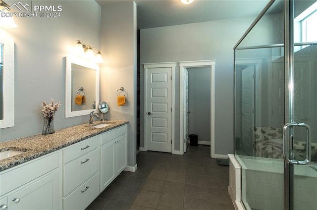 bathroom with tile patterned floors, vanity, and walk in shower