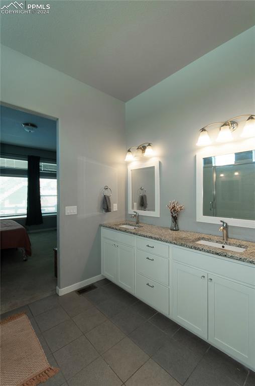 bathroom with tile patterned flooring and vanity