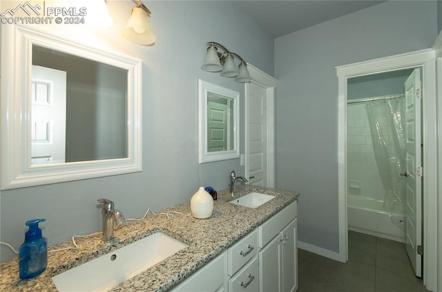 bathroom with shower / bath combo with shower curtain, vanity, and tile patterned flooring