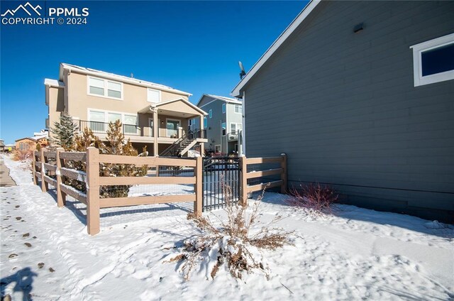 view of snow covered rear of property