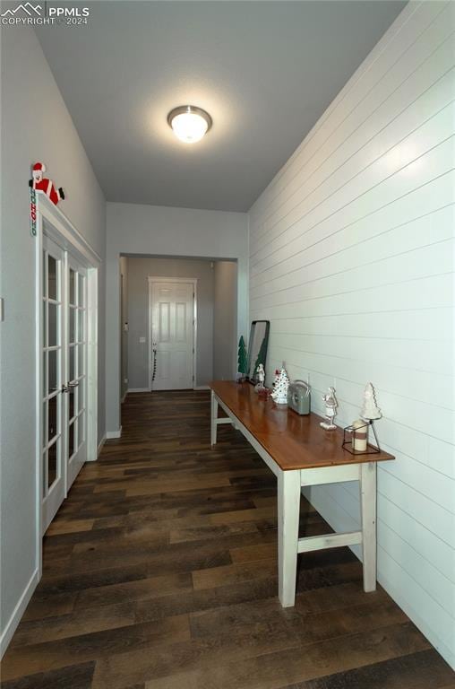 corridor featuring french doors and dark wood-type flooring