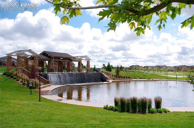 exterior space featuring a lawn and a water view