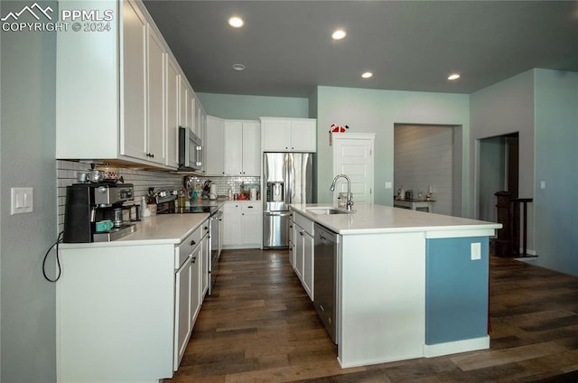 kitchen with white cabinets, stainless steel appliances, a kitchen island with sink, and sink