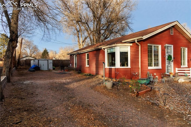 view of property exterior featuring a shed