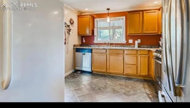 kitchen featuring decorative light fixtures, sink, and appliances with stainless steel finishes