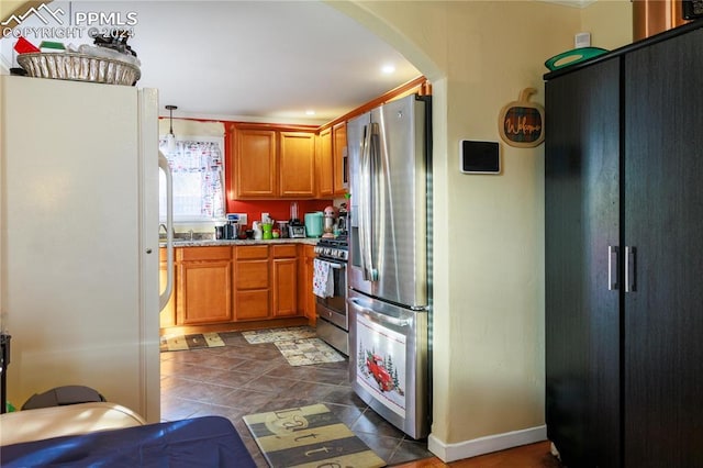 kitchen featuring hanging light fixtures and appliances with stainless steel finishes