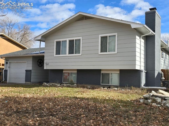 rear view of house with a garage