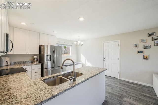 kitchen with white cabinetry, sink, dark hardwood / wood-style flooring, decorative light fixtures, and appliances with stainless steel finishes