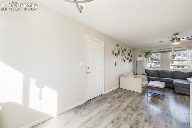 living room with hardwood / wood-style flooring and ceiling fan