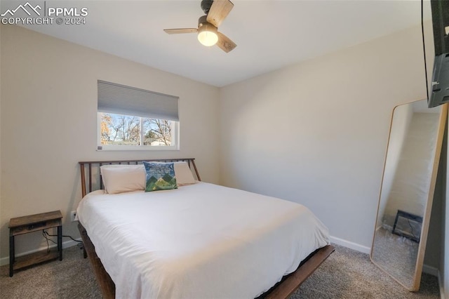 bedroom with dark colored carpet and ceiling fan