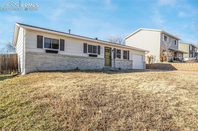 view of front of property with a garage and a front yard