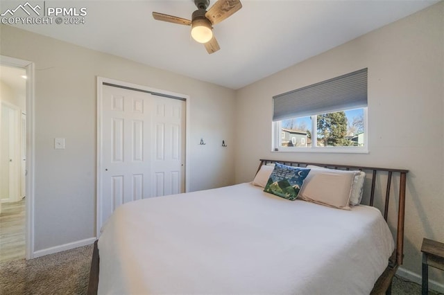 bedroom with carpet, ceiling fan, and a closet