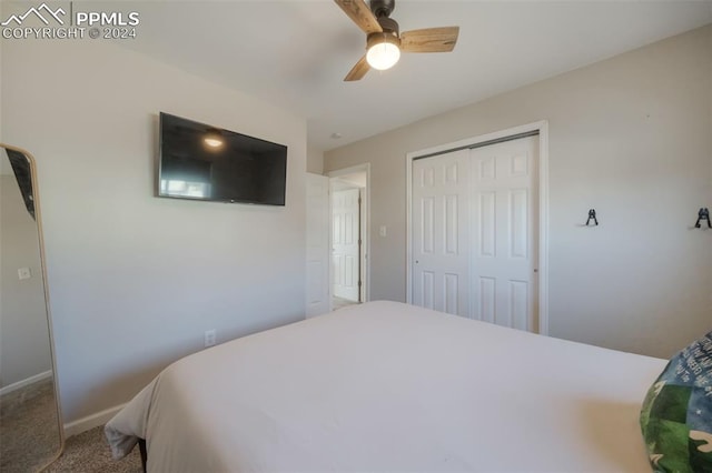 carpeted bedroom with a closet and ceiling fan