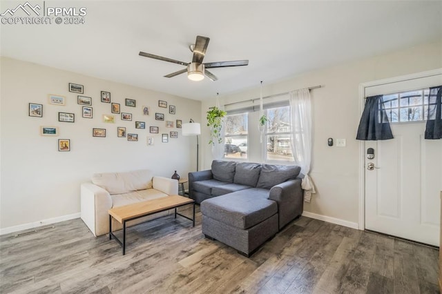 living room featuring hardwood / wood-style flooring and ceiling fan