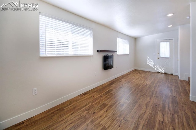 interior space with dark hardwood / wood-style floors and vaulted ceiling