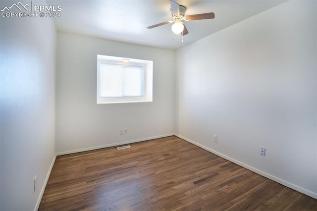 spare room with ceiling fan and dark hardwood / wood-style floors