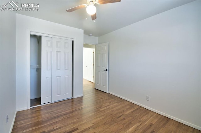 unfurnished bedroom featuring a closet, dark hardwood / wood-style floors, and ceiling fan