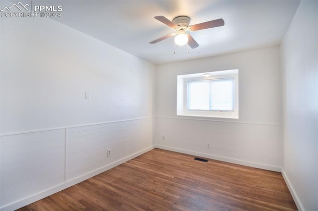 unfurnished room with hardwood / wood-style flooring and ceiling fan