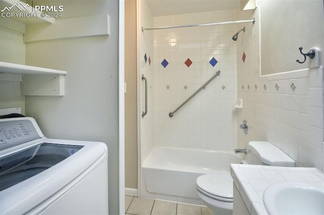 full bathroom with vanity, tile patterned flooring, washer / clothes dryer, toilet, and tiled shower / bath