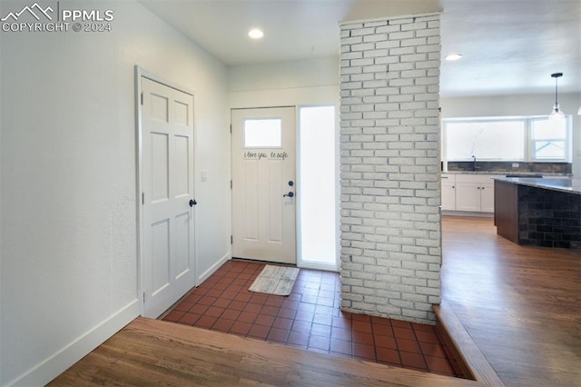 entryway with plenty of natural light and dark hardwood / wood-style flooring